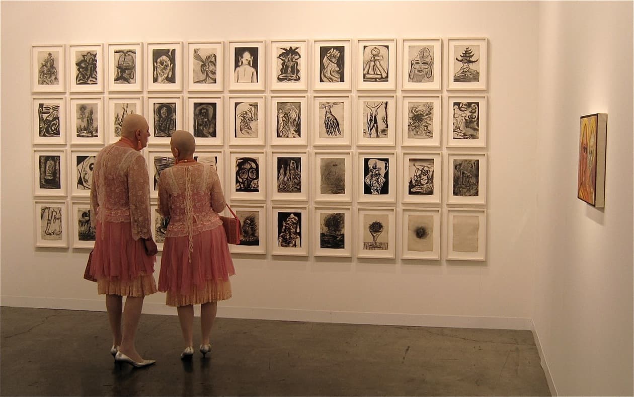 Art lovers at a gallery during Art Basel in Miami in Towleroad and ManAboutWorld gay travel magazine
